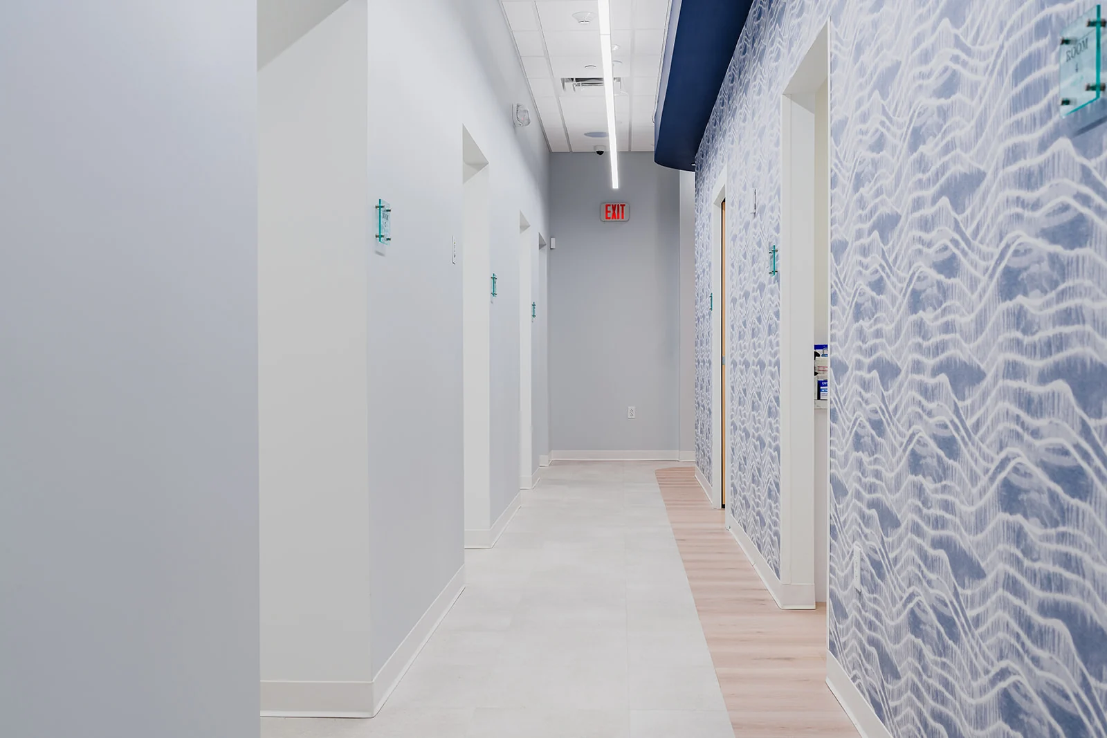 Dental 365 clinical corridor with blue patterned wallcovering