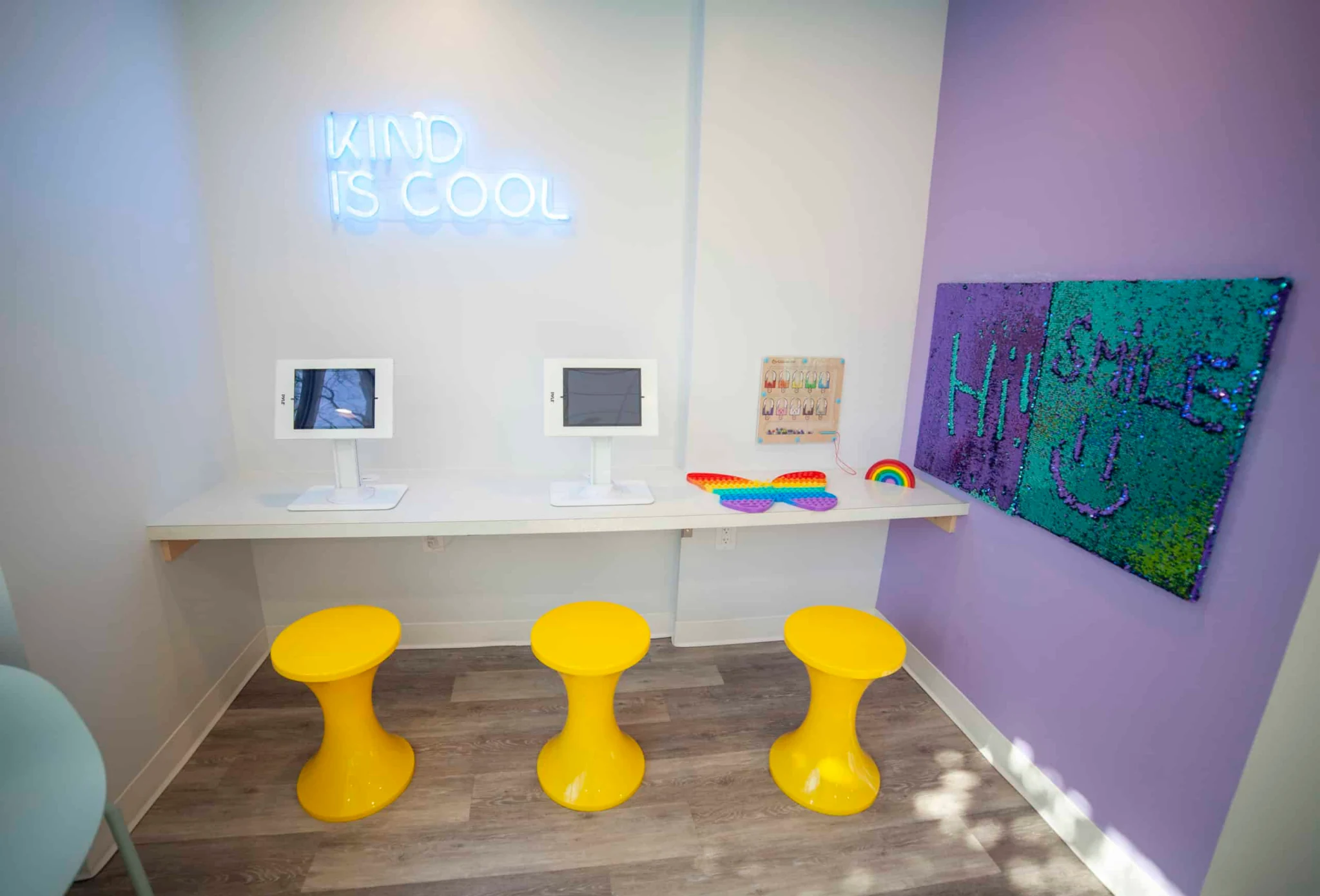 North Shore Smiles children’s activity area with yellow stools